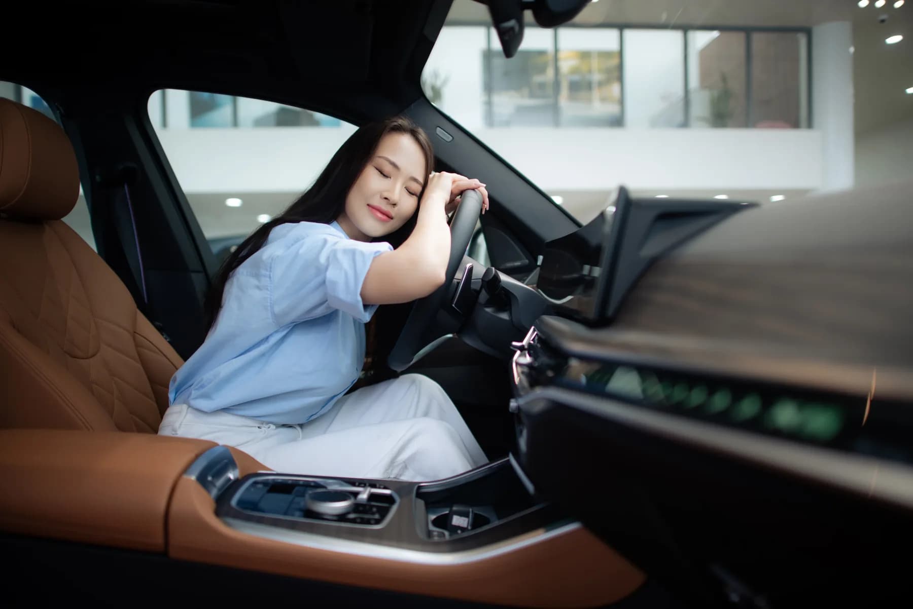 Driver pausing in a quiet moment behind the wheel of her vehicle